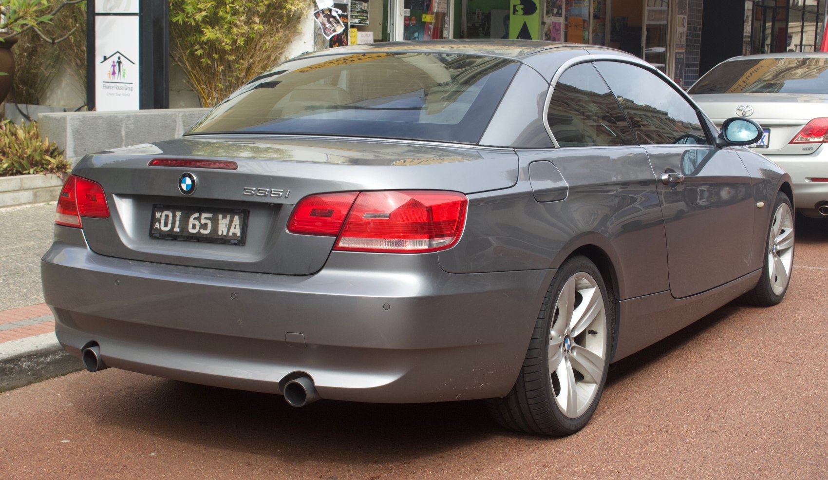 Rear view of BMW 3 Series Convertible with dual exhausts and alloy wheels