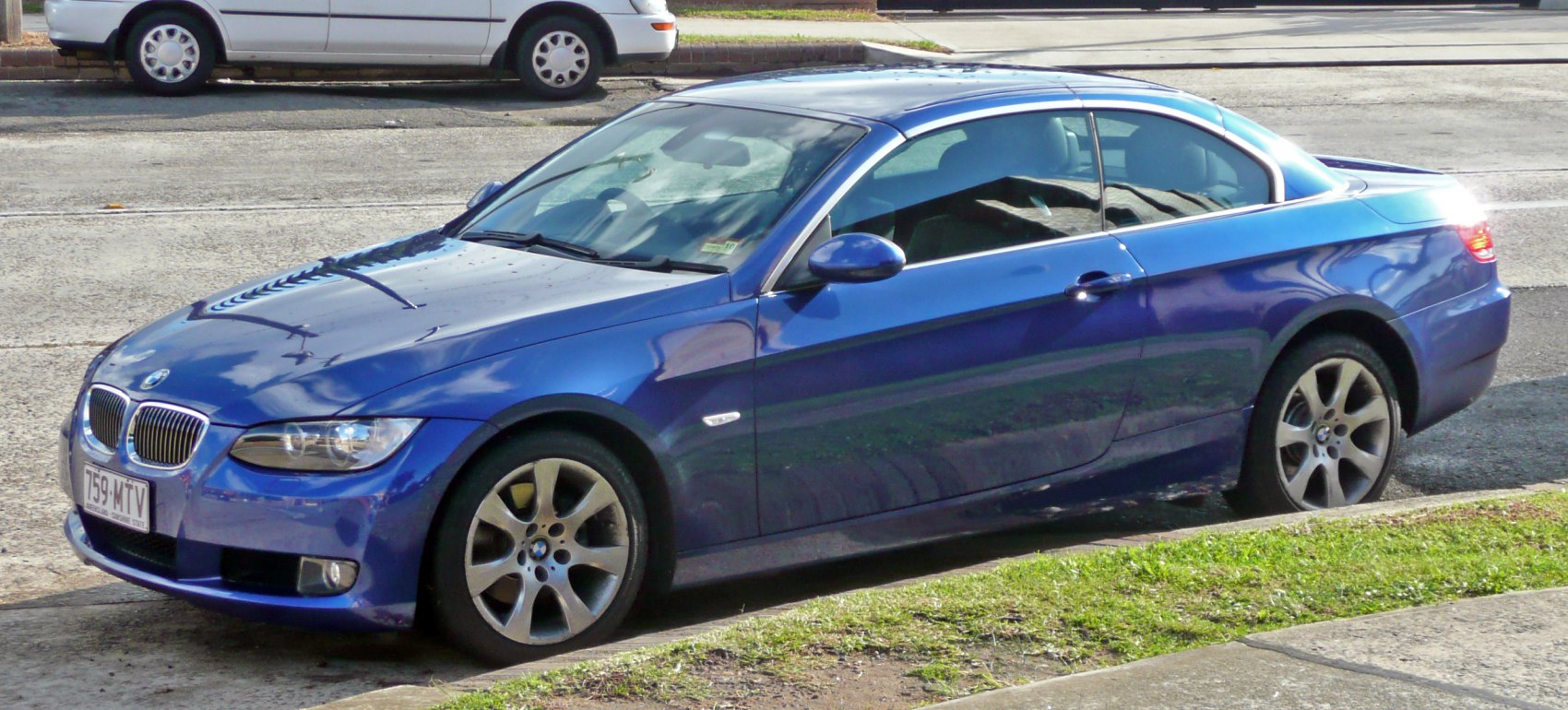 Blue car, front-side view with alloy wheels.