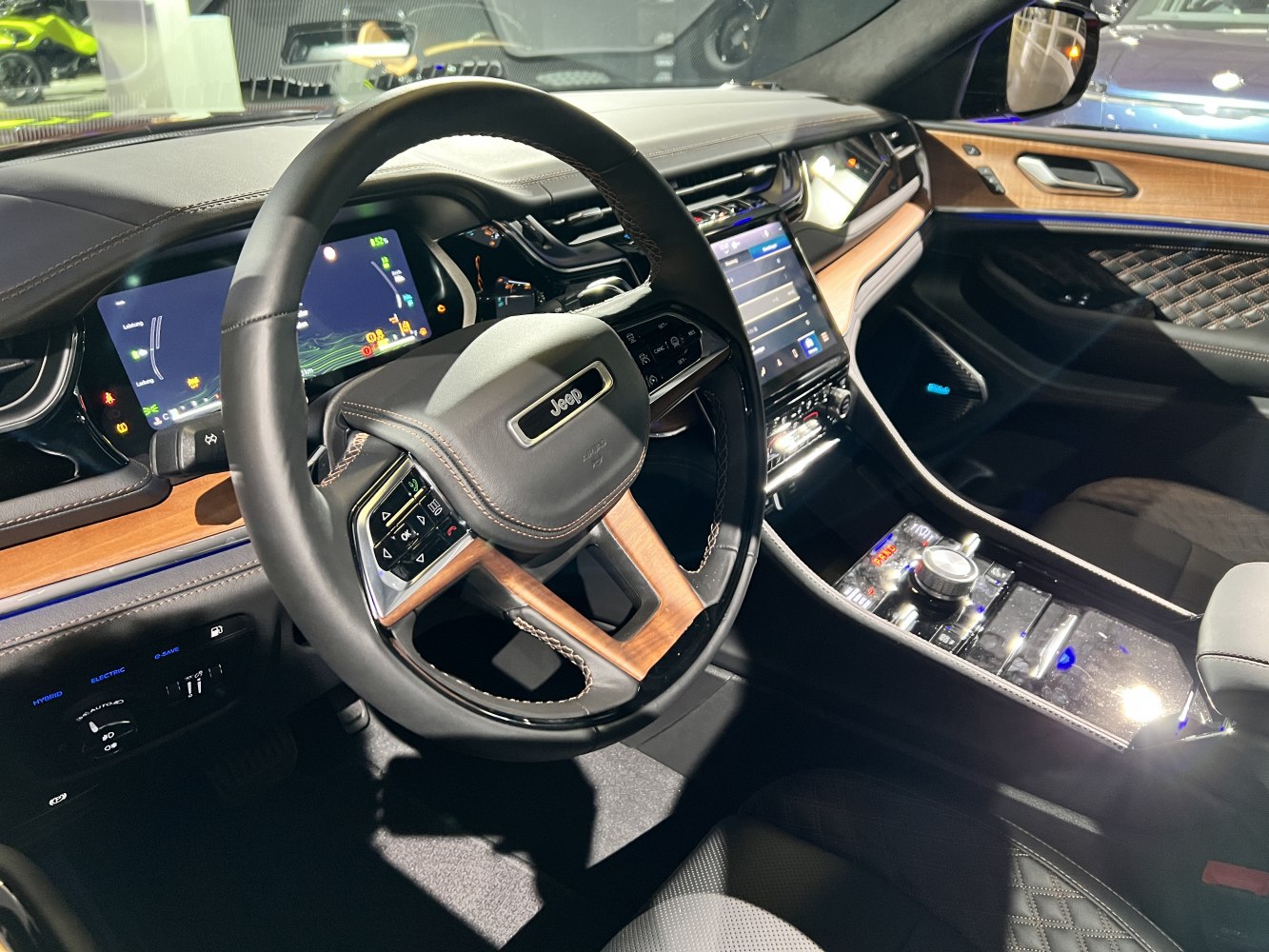 Steering wheel with wooden accents, digital instrument cluster, touchscreen center console