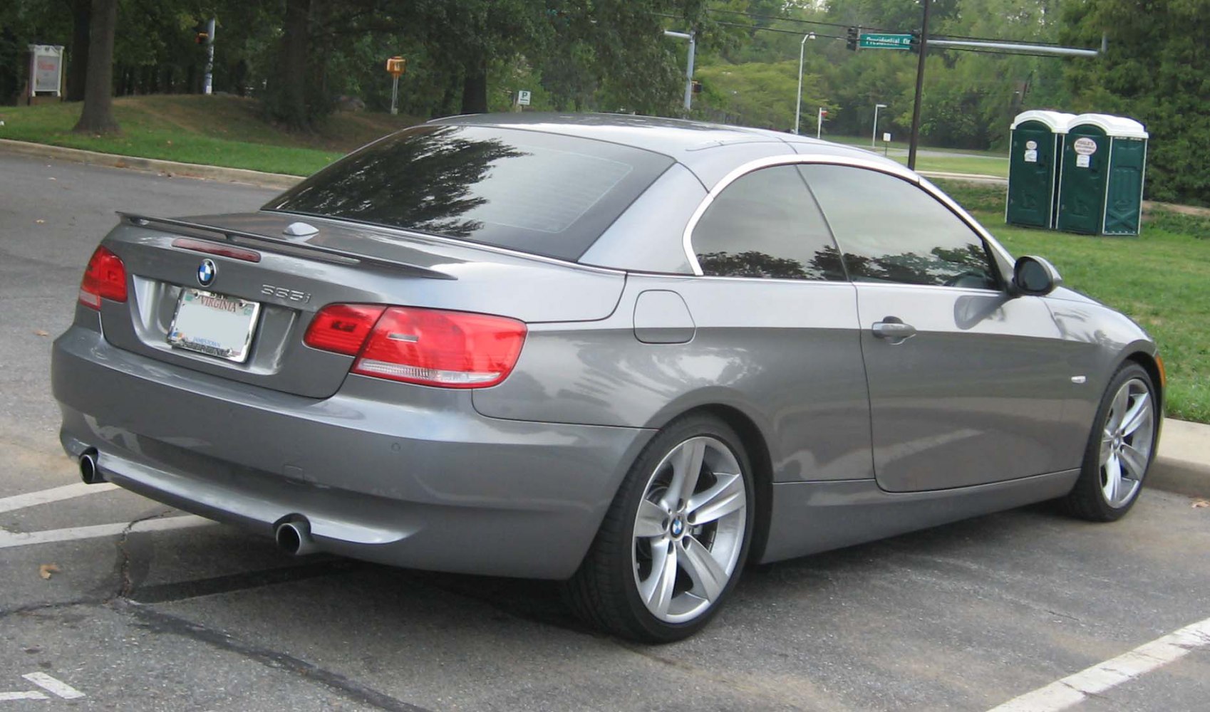 Rear and side profile of a metallic grey convertible with dual exhausts