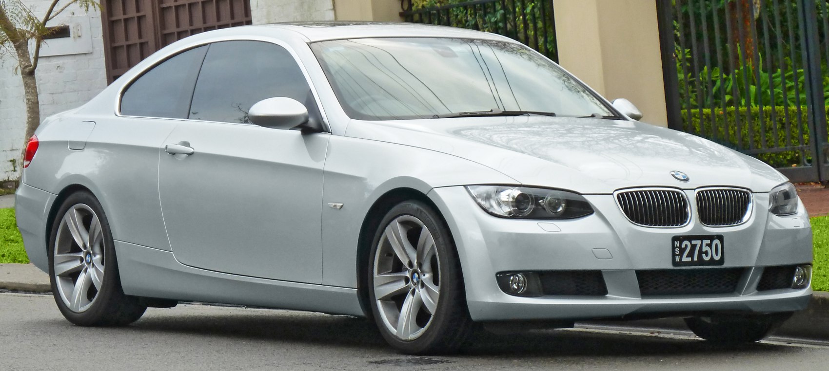 Silver coupe with kidney grille and alloy wheels front side view