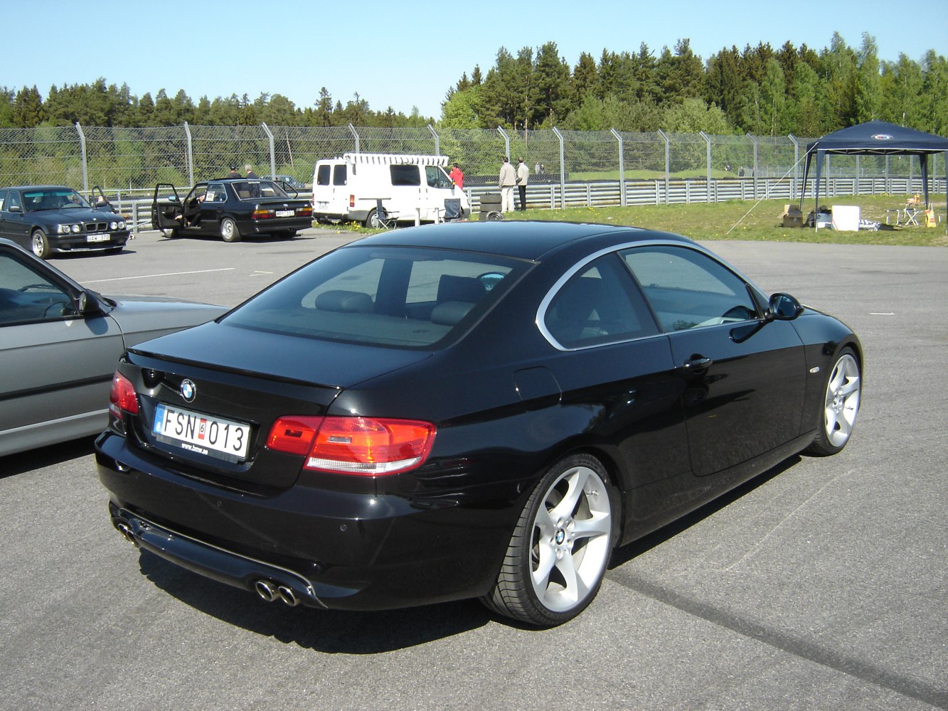 Rear view of sleek coupe with quad exhaust and alloy wheels