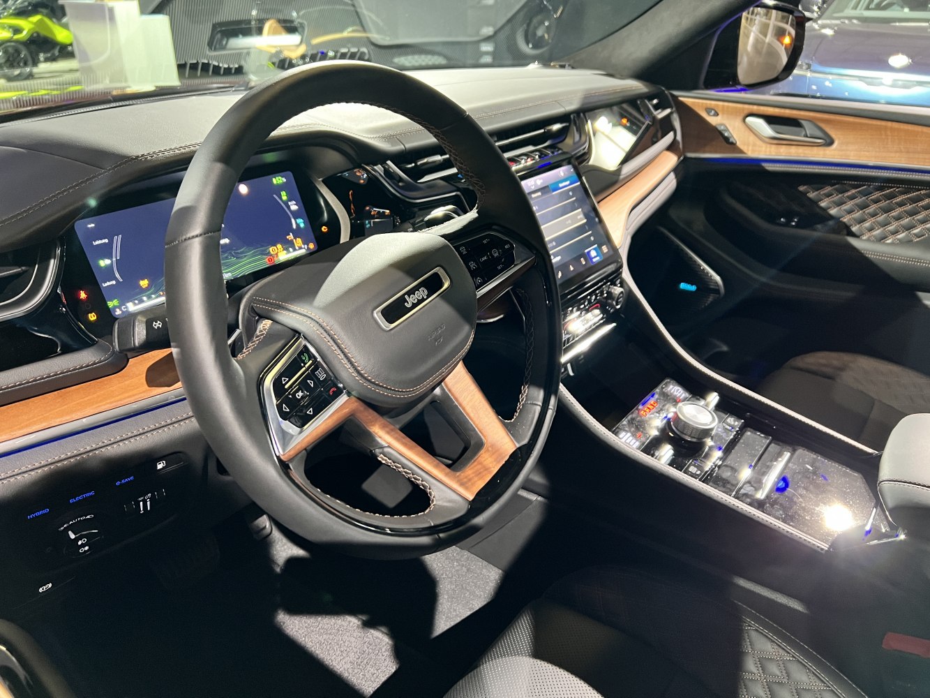 Luxury SUV interior with digital dash and wood-trimmed steering wheel
