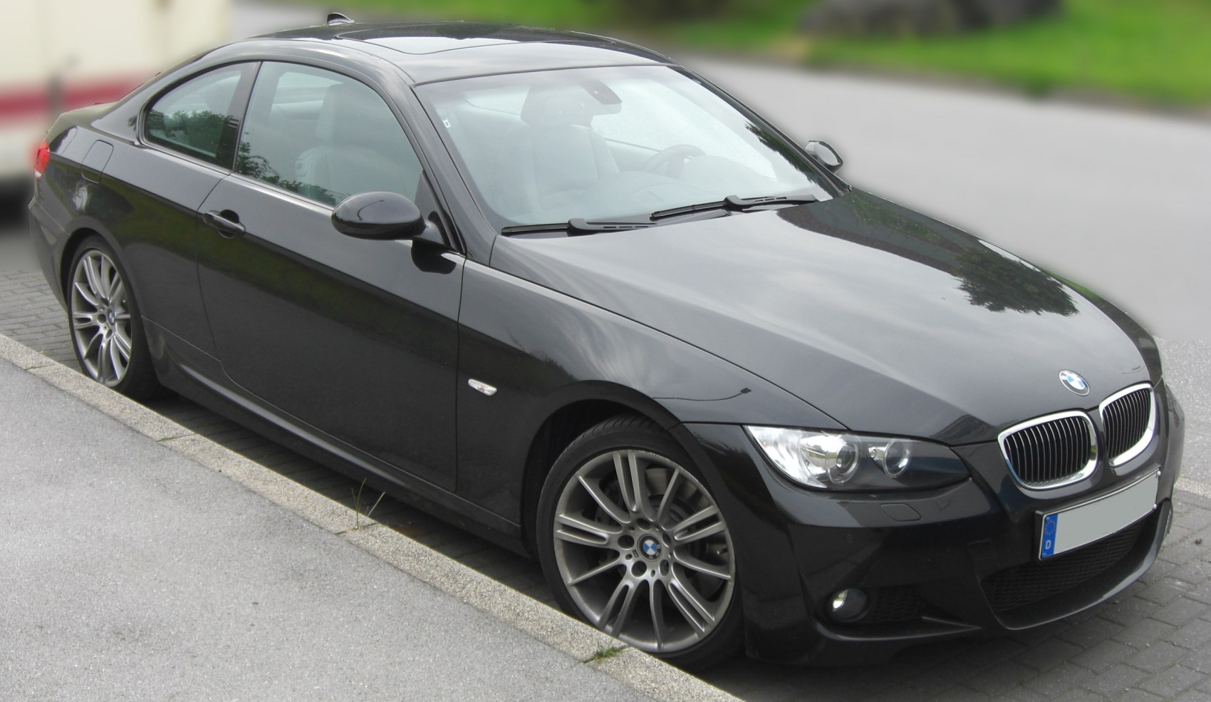 Black coupe with sporty alloy wheels and signature kidney grille