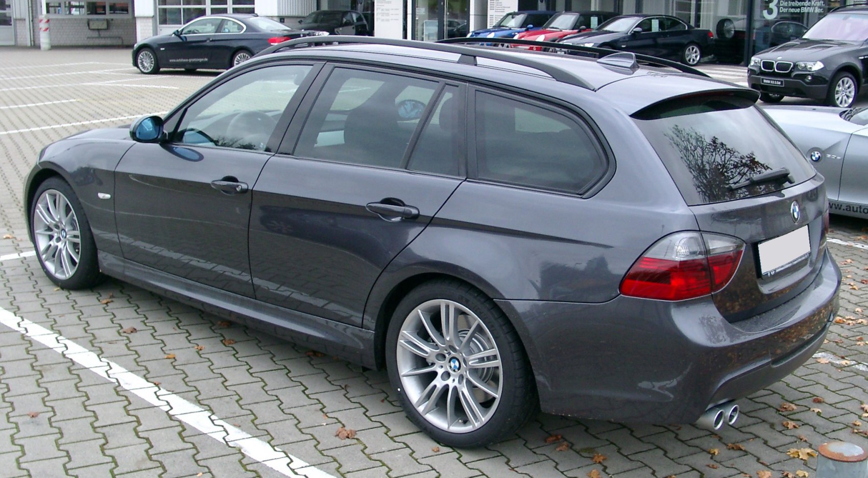 Rear side view of station wagon with alloy wheels and roof rails