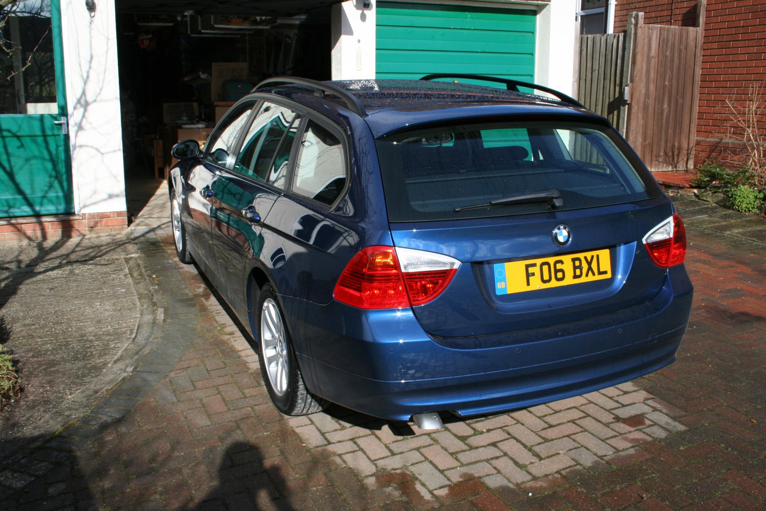 Rear angle of blue estate with distinct taillights and roof rails