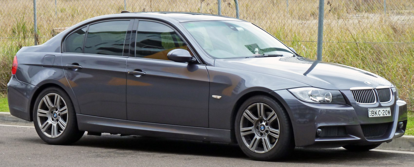 Front-side view of sedan with alloy wheels and tinted windows