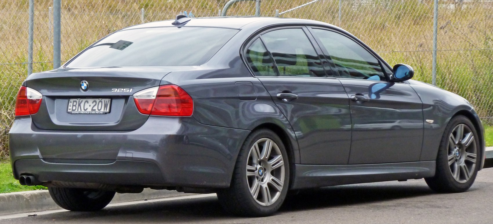 Rear and side profile of a four-door sedan with alloy wheels