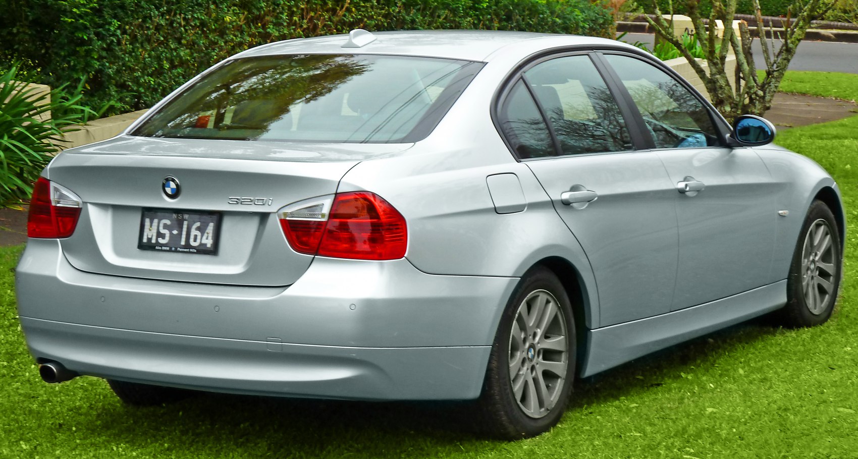 Silver 3 Series Sedan rear view with taillights and exhaust