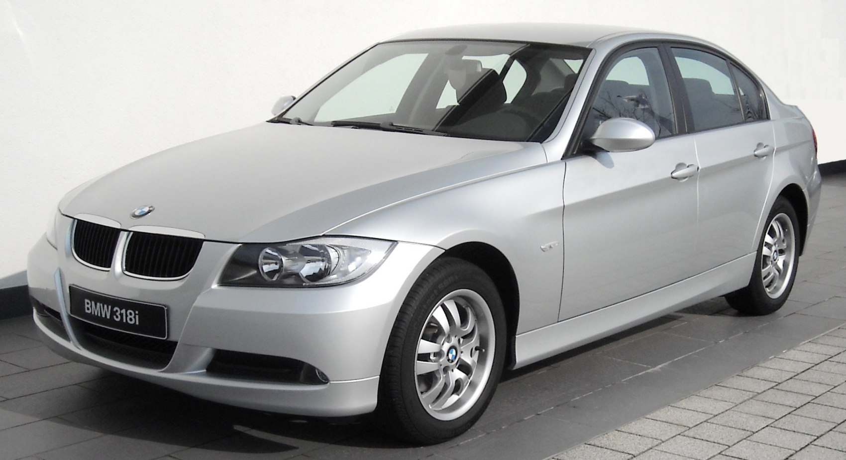 Front-side view of silver sedan with alloy wheels and distinct headlights