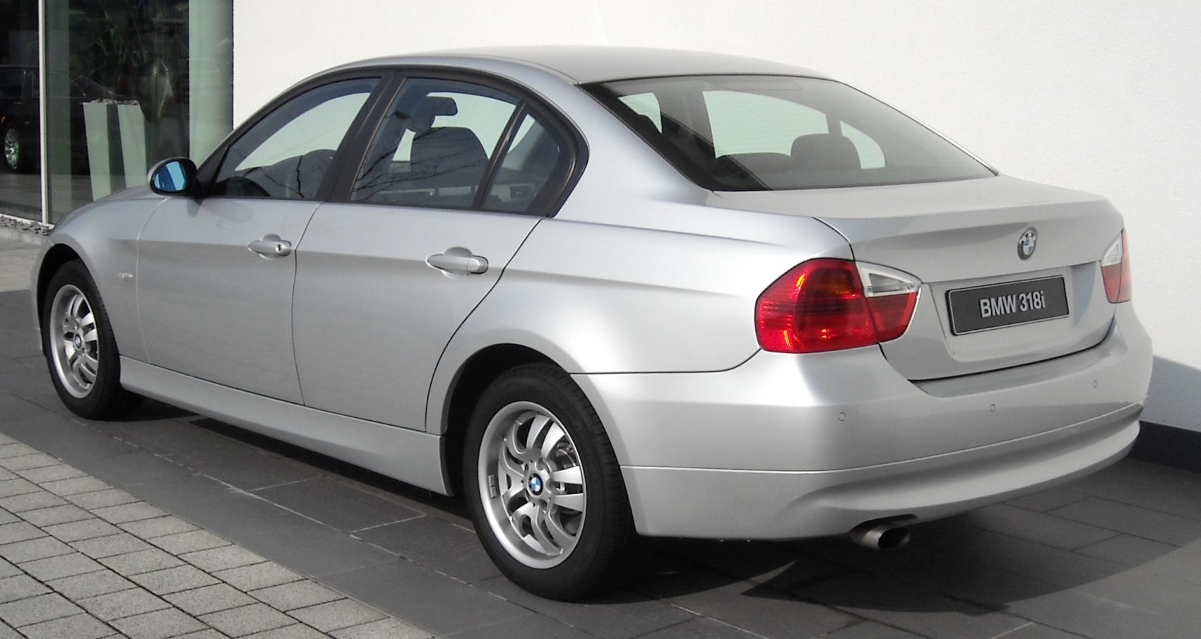 Silver sedan rear-side view with distinct tail light and alloy wheels