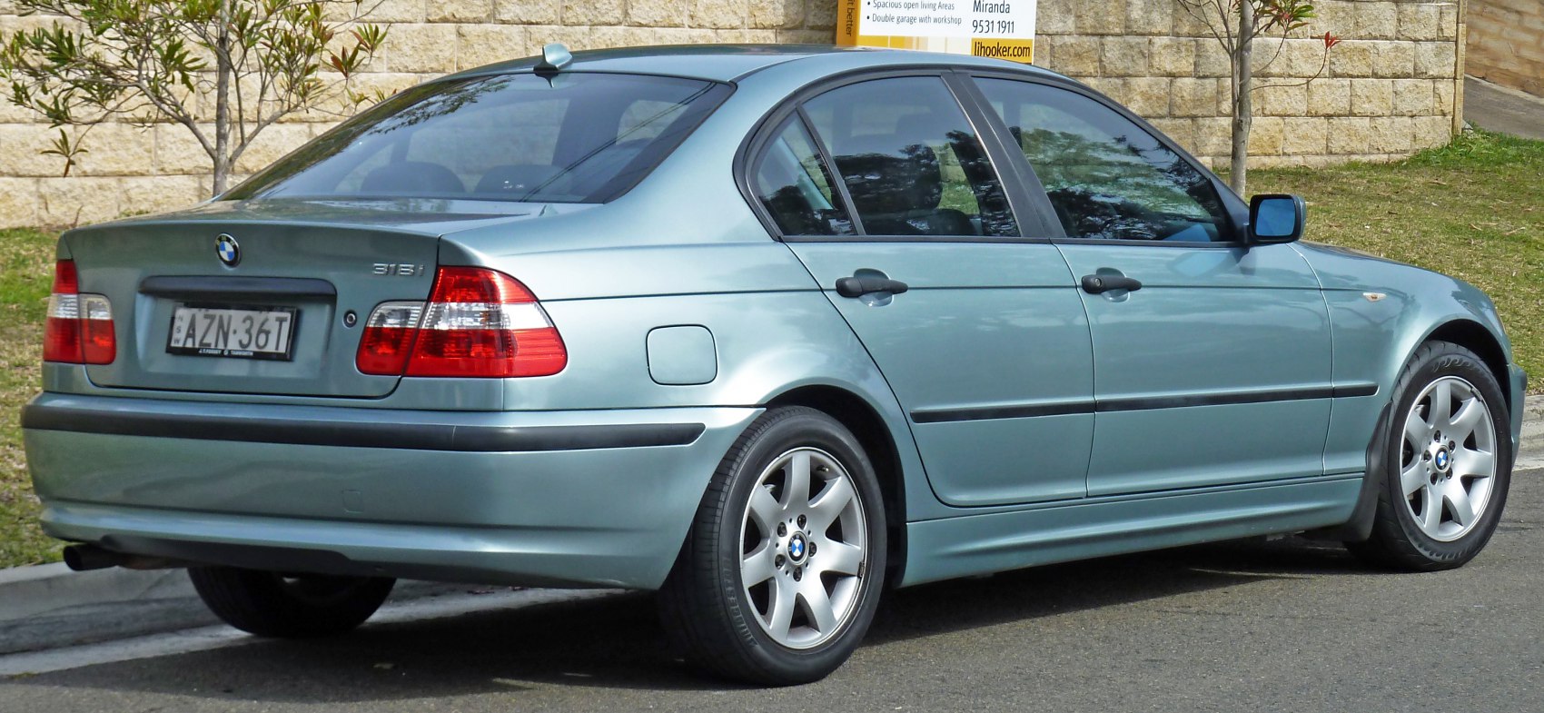 Rear and side view of a sedan with alloy wheels and clear taillights
