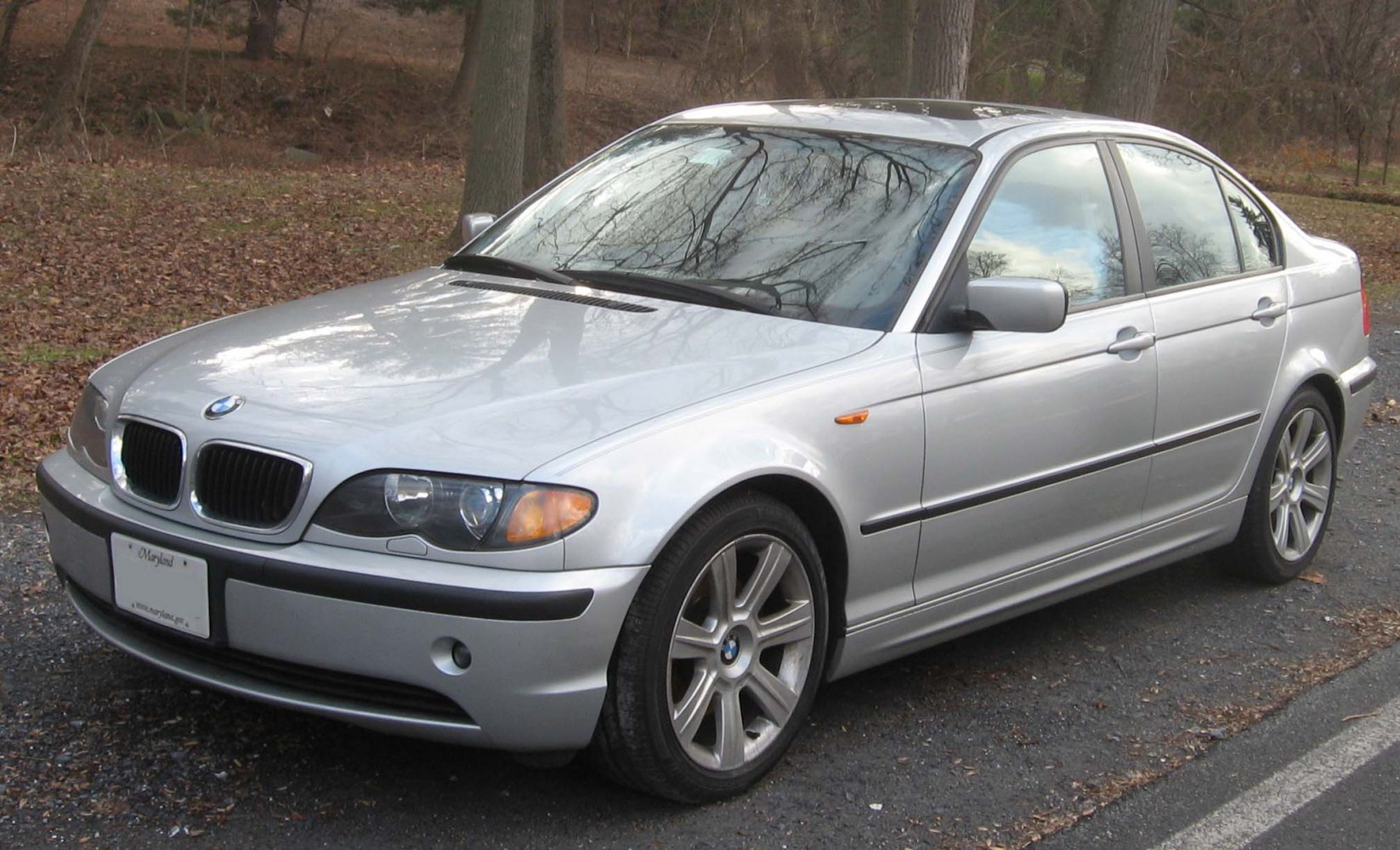Silver sedan front side view with alloy wheels and classic headlights
