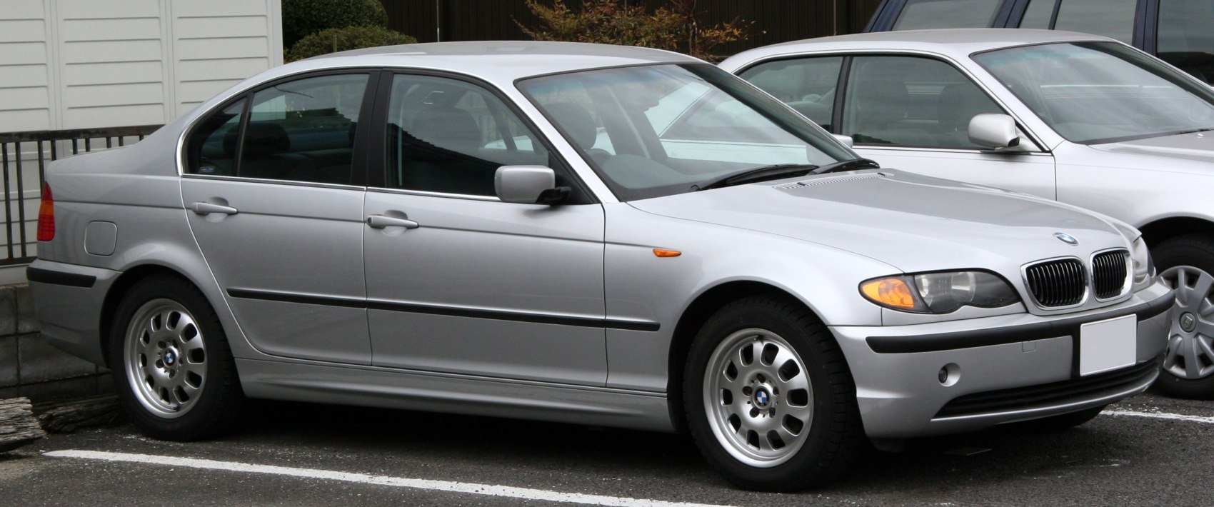 Silver sedan side view with alloy wheels and smooth body lines