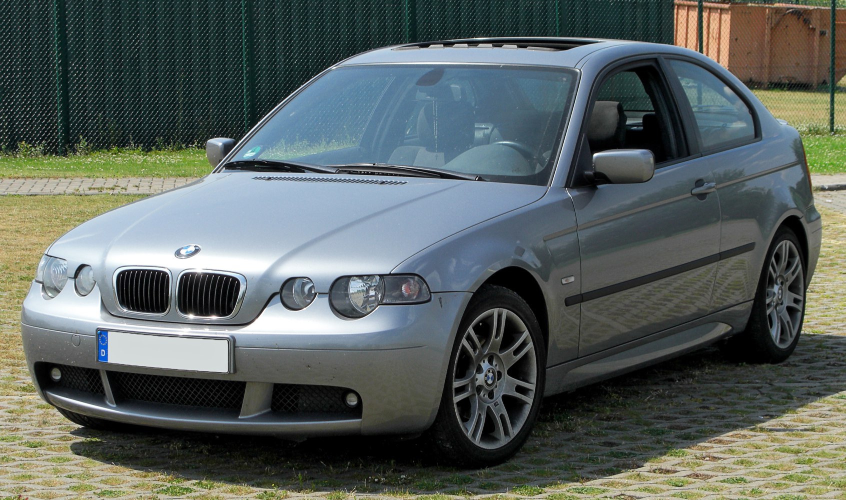 Silver sporty 3-door coupe with distinctive front end and alloy wheels