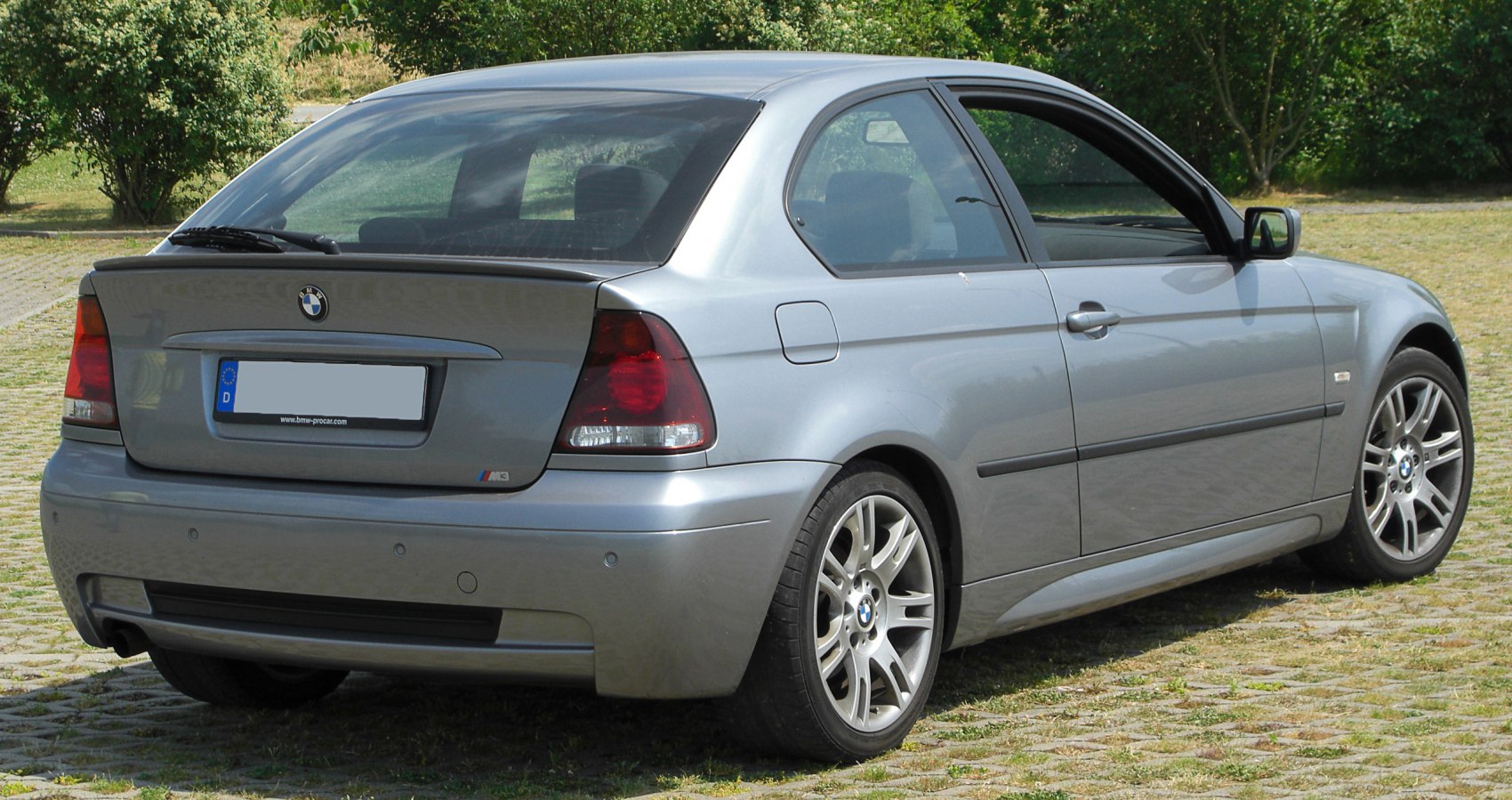 Rear perspective of hatchback with distinct taillights and multi-spoke alloy wheels