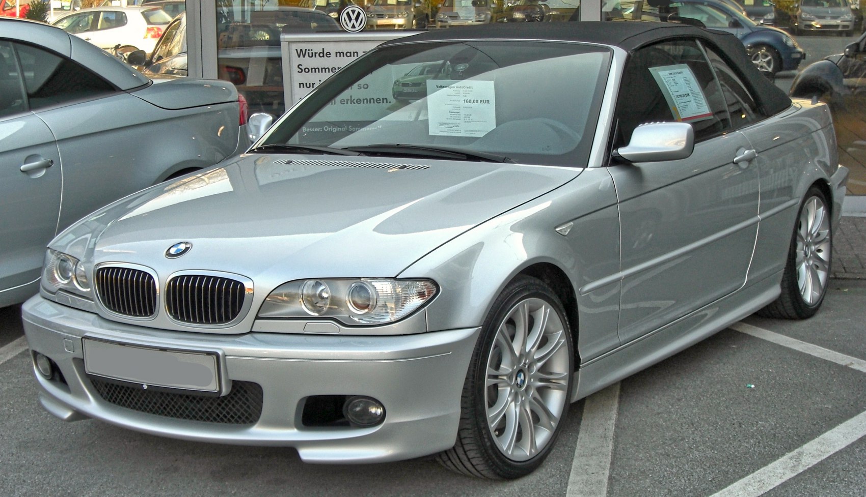 Front view of silver convertible with kidney grille and soft top roof