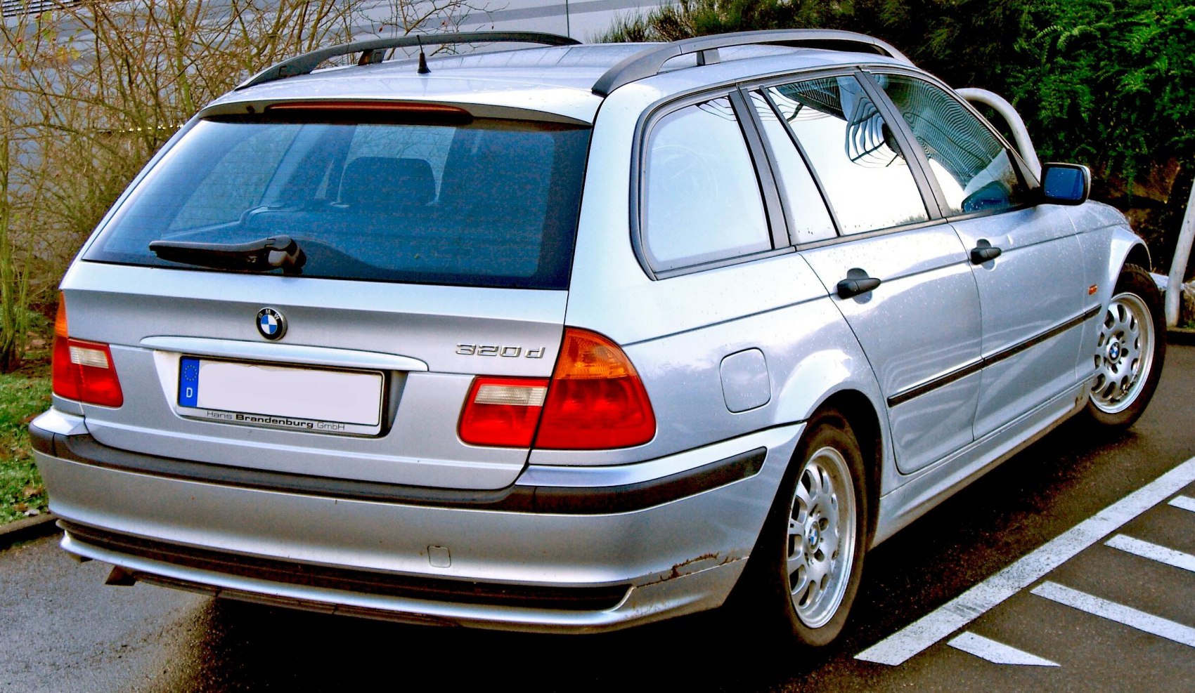 Rear view of a 320d estate car with roof rails and rear wiper
