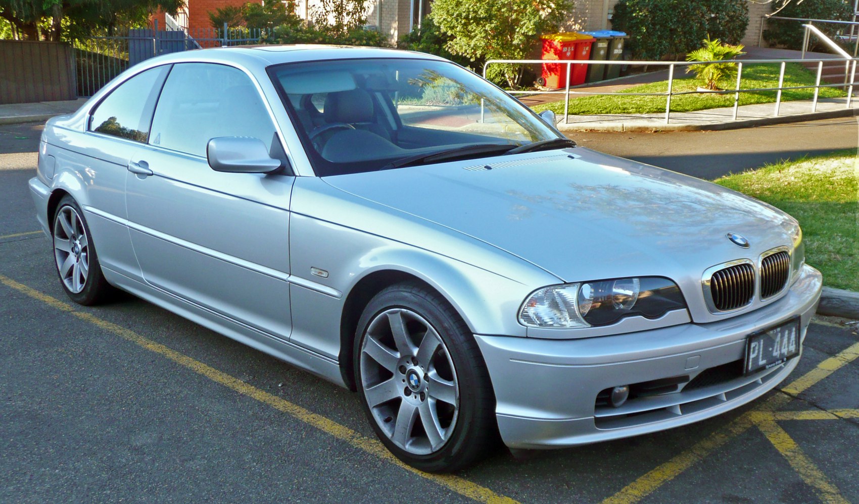 Silver coupe showing front side with headlights and alloy wheels
