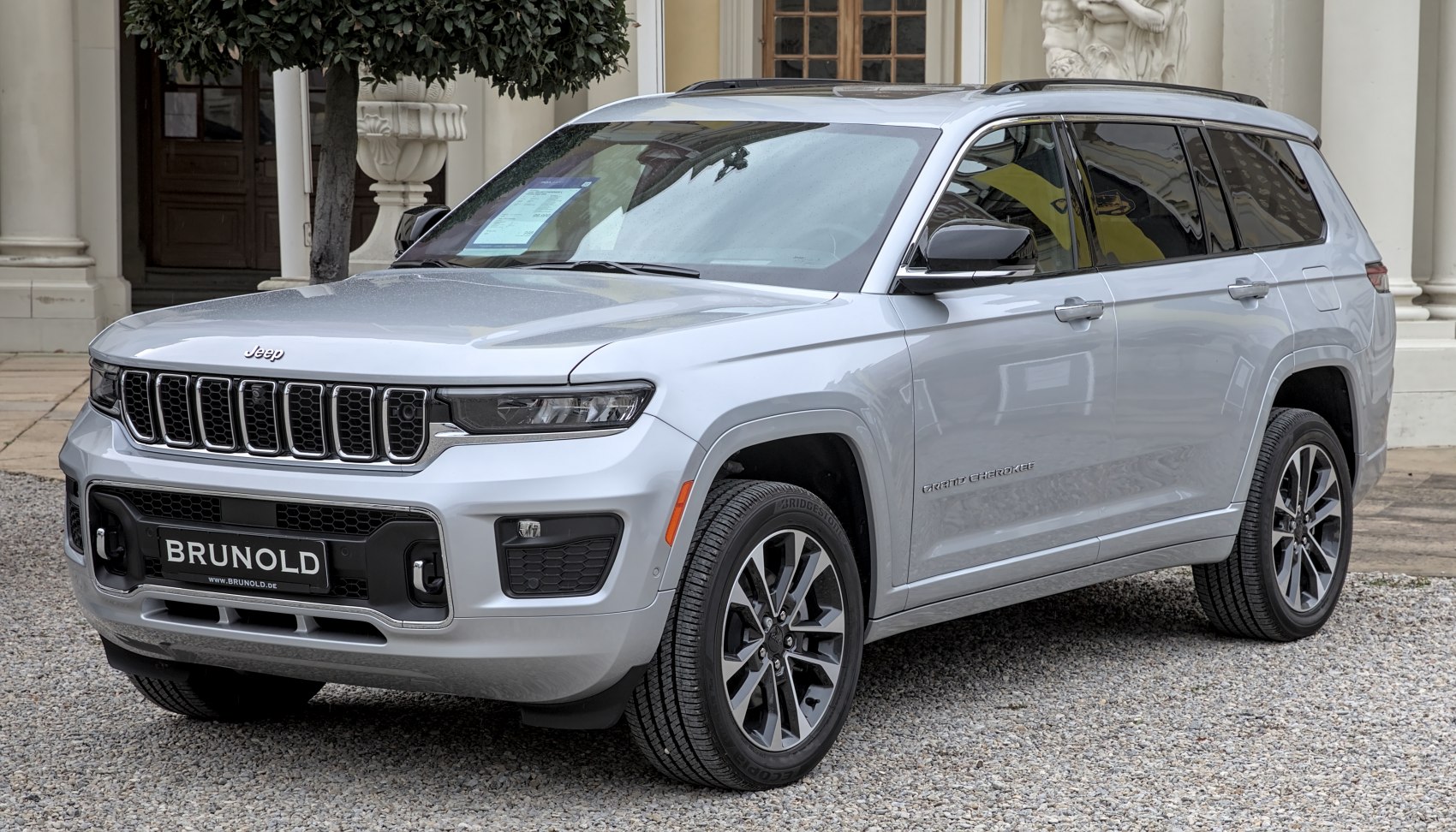 Front side view of a silver SUV with LED headlights and alloy wheels