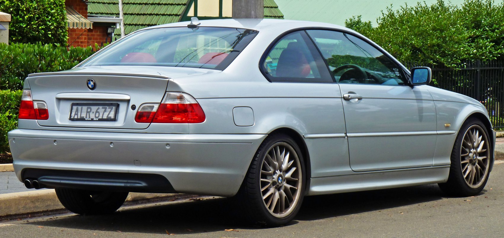 Silver BMW coupe rear and side profile with sporty design features