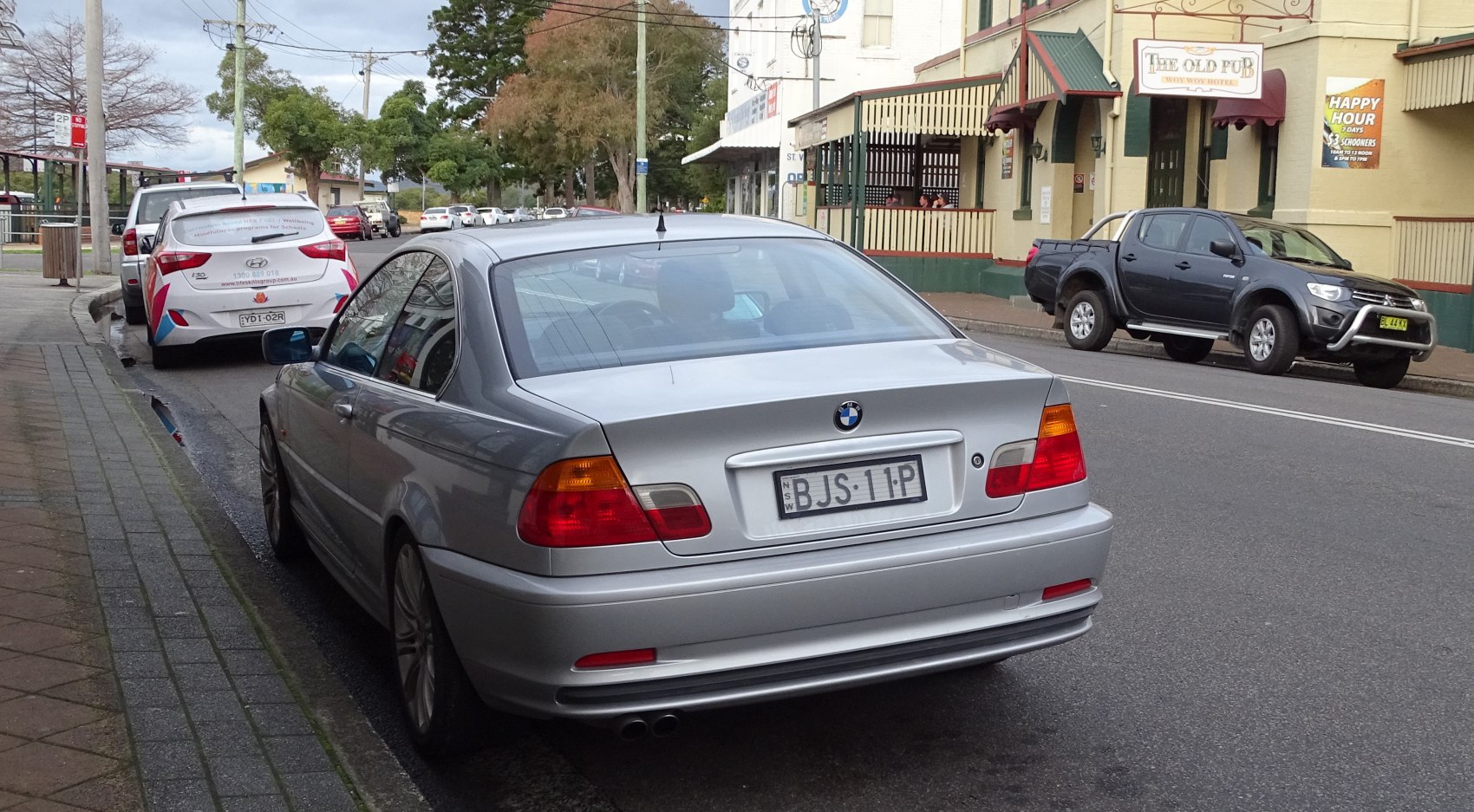 Silver coupe rear with taillights and dual exhausts