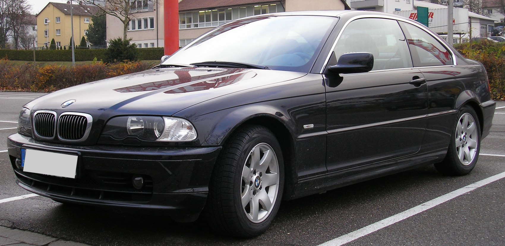 Black coupe front and side view with kidney grille and headlights