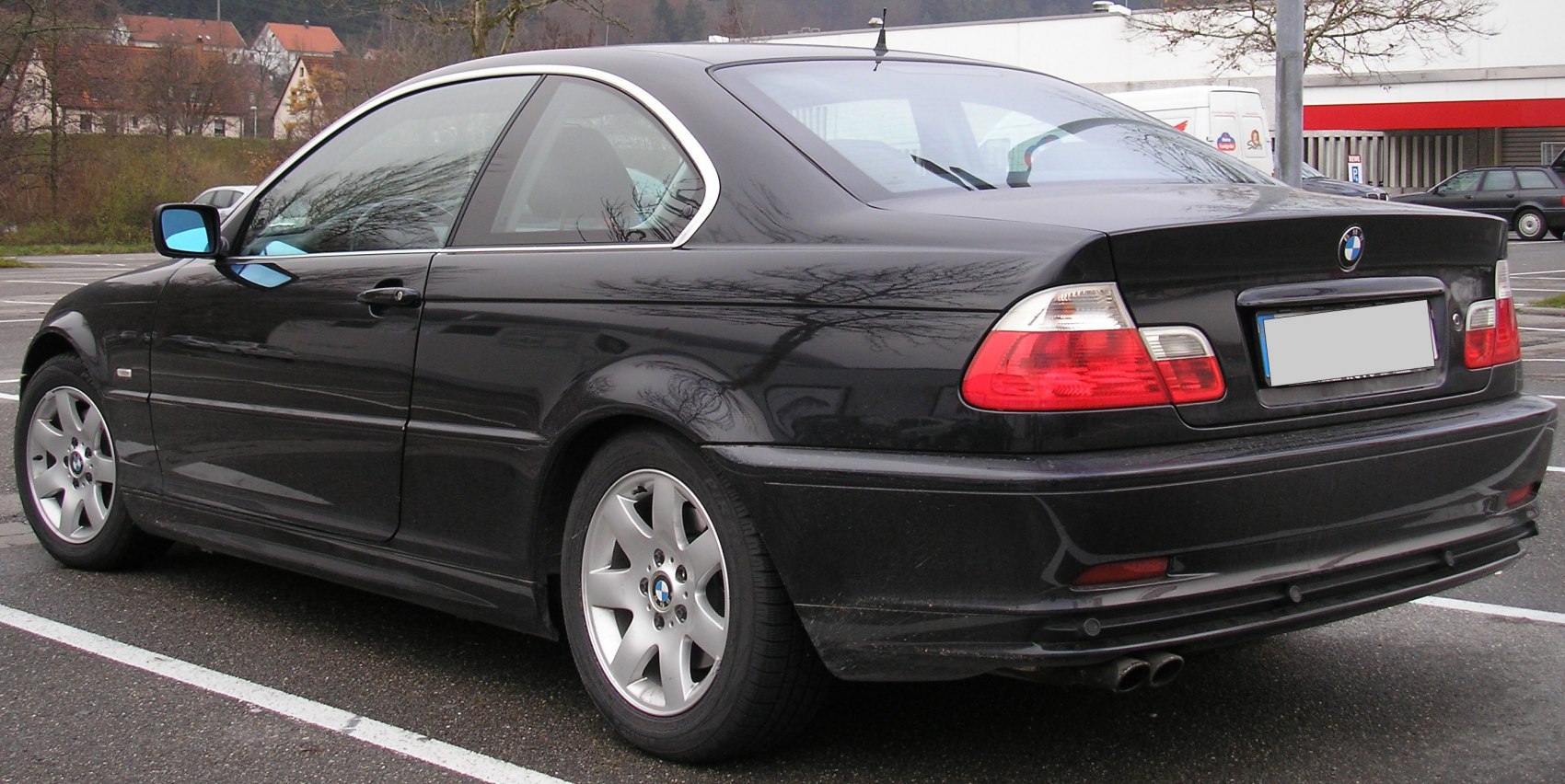 Rear-side view of a black 3 Series coupe with alloy wheels and taillights