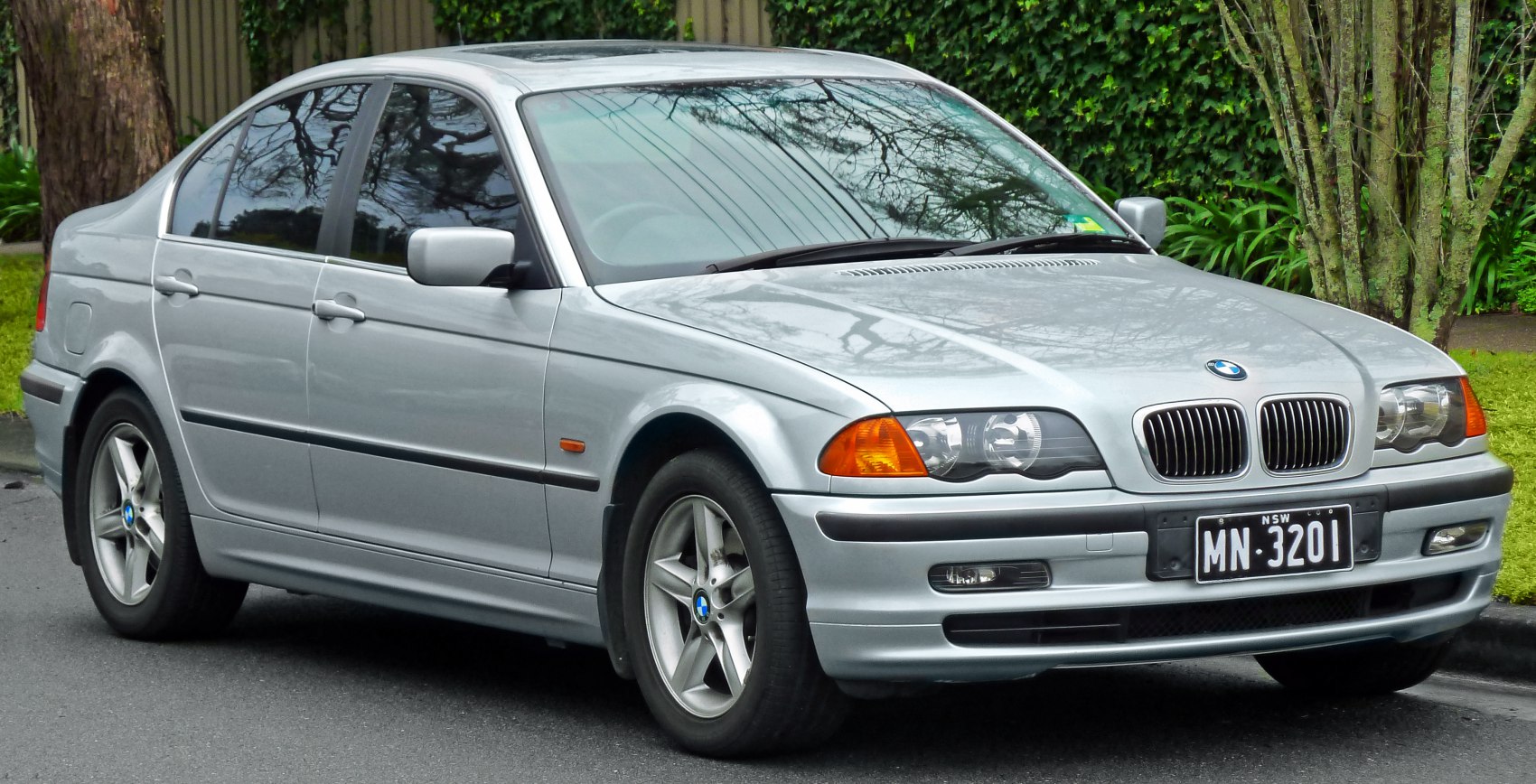 Silver sedan with dual round headlights and kidney grille