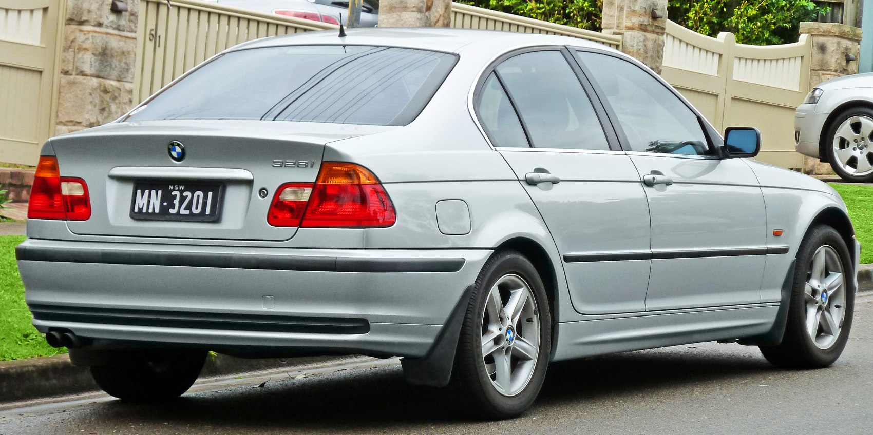 Silver sedan rear and side with alloy wheels and taillights