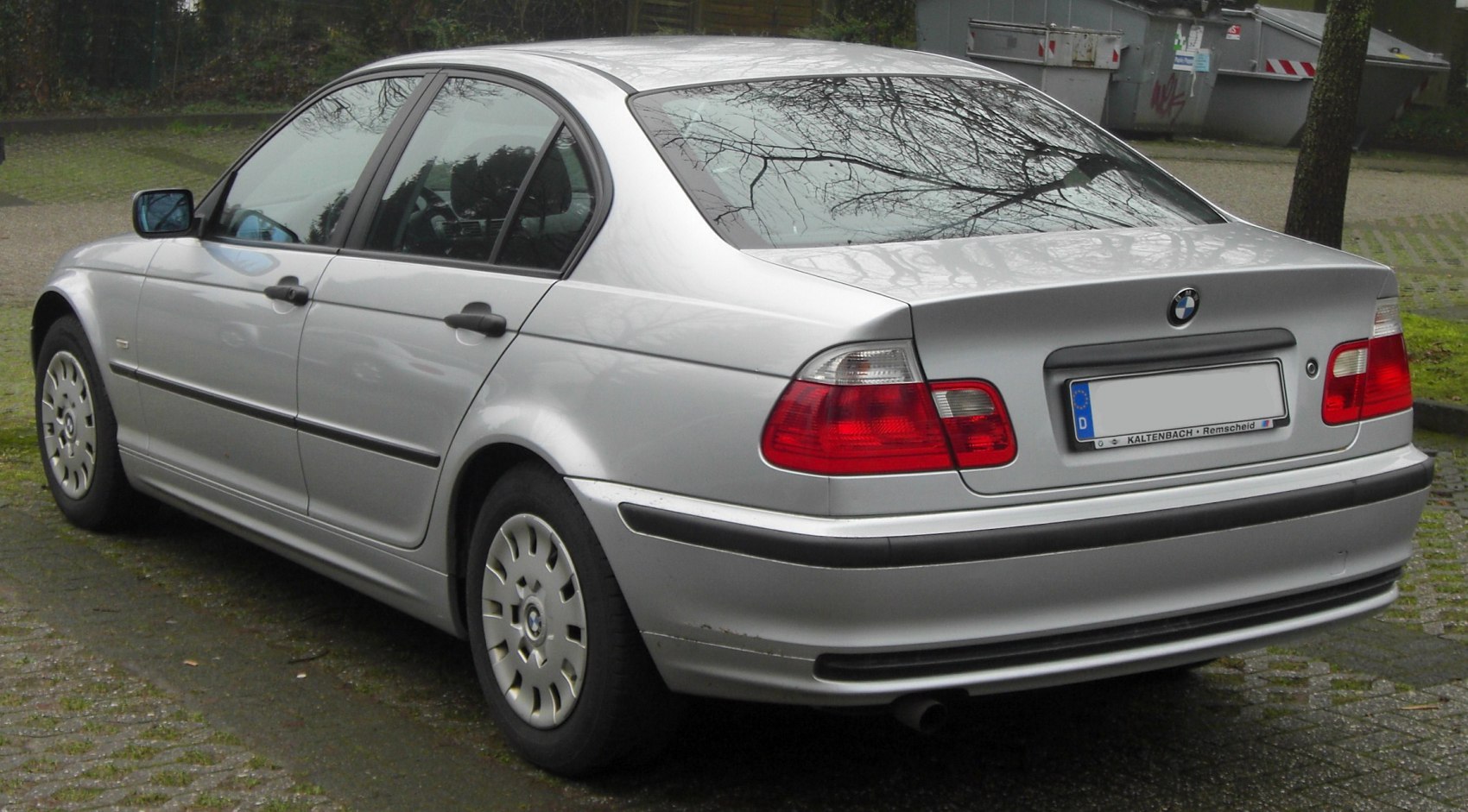 Silver sedan rear side view with distinctive tail lights and streamlined design