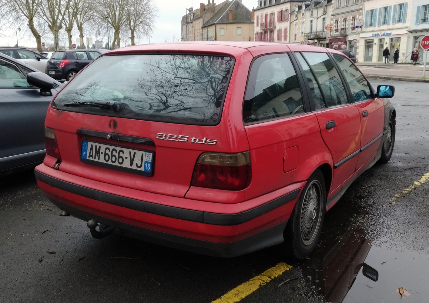 Rear view of red estate car with tail lights and towing hitch