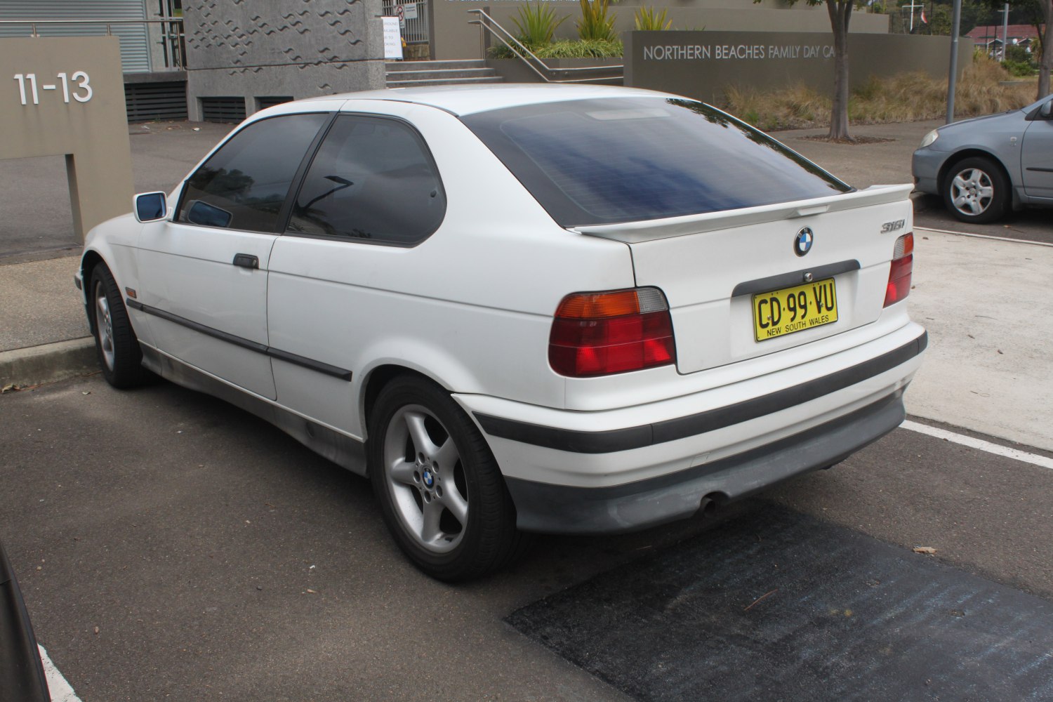 Rear side hatchback view with tinted windows and rear spoiler