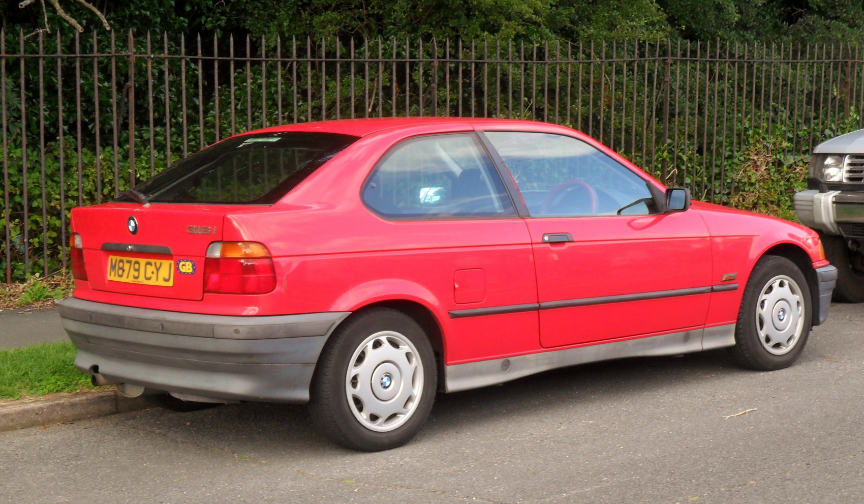 Red 3-door hatchback with distinct rear and alloy wheels