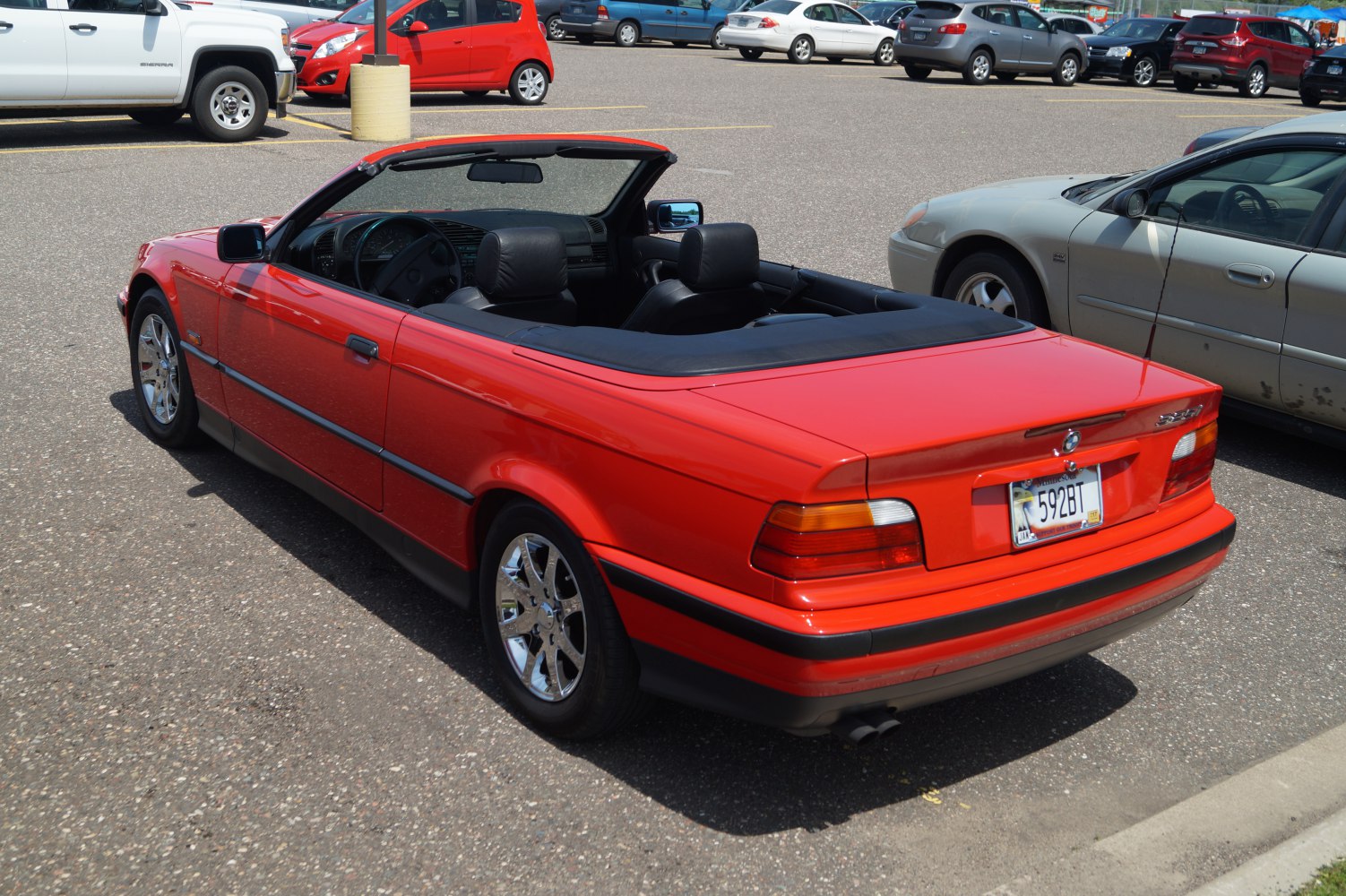 Red convertible with open roof and chrome wheels