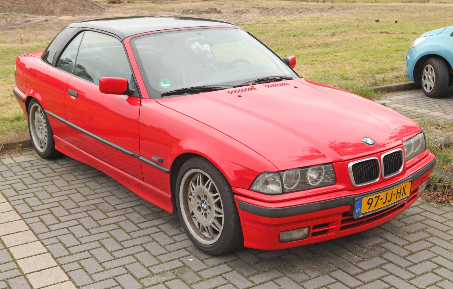 Red convertible with closed hardtop and classic alloy wheels
