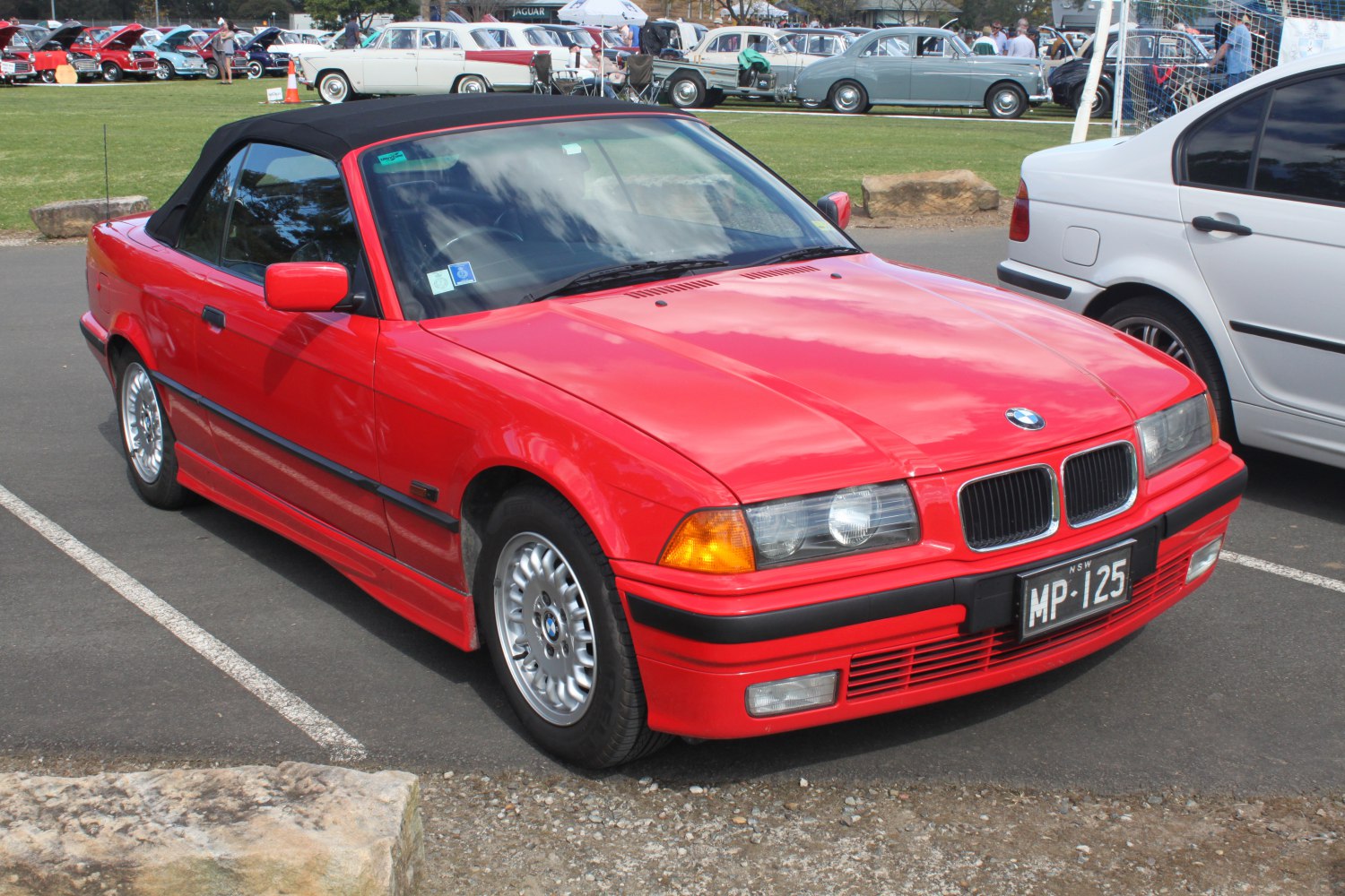 Red convertible with black soft top and alloy wheels