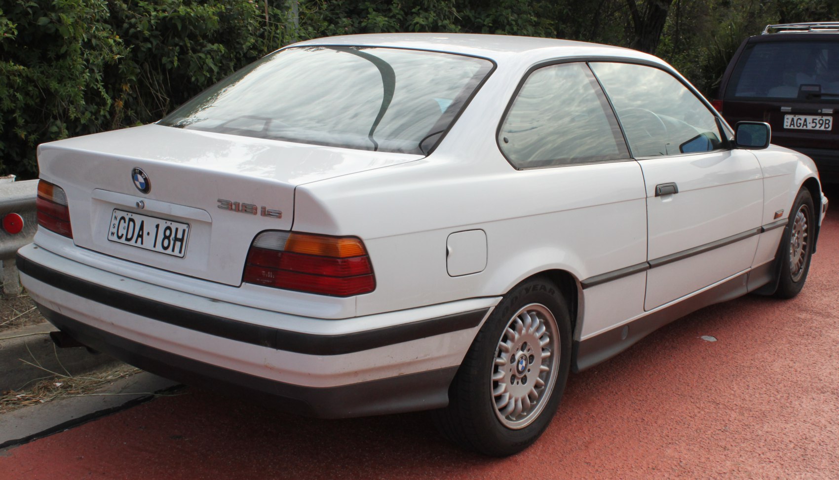 Rear and side view of classic coupe with distinctive taillights and alloy wheels