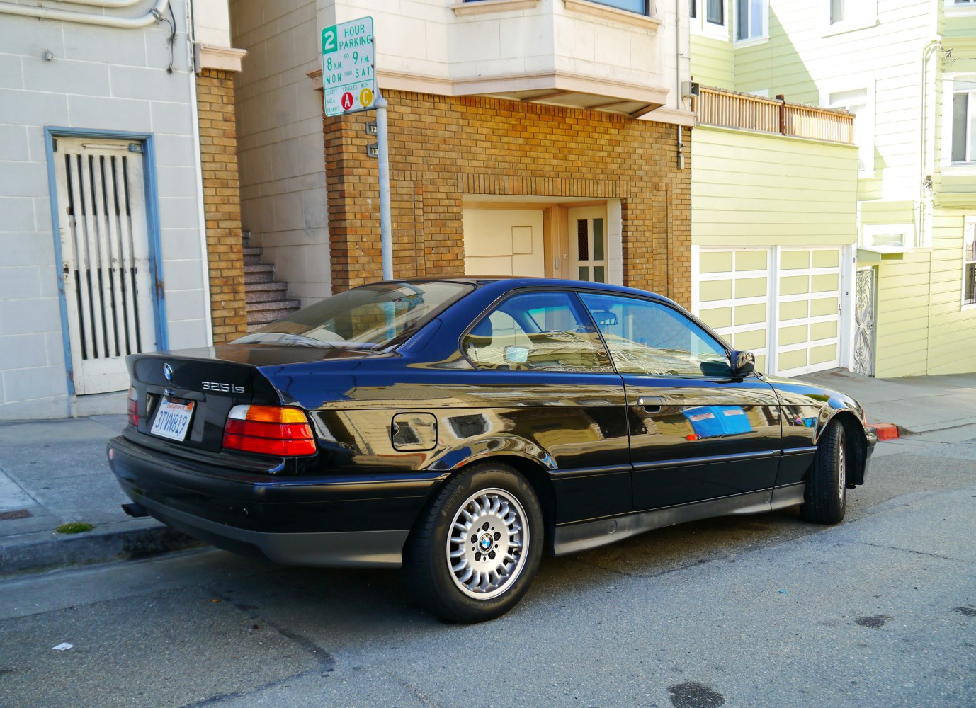 Rear view and alloy wheels of a 1990s coupe