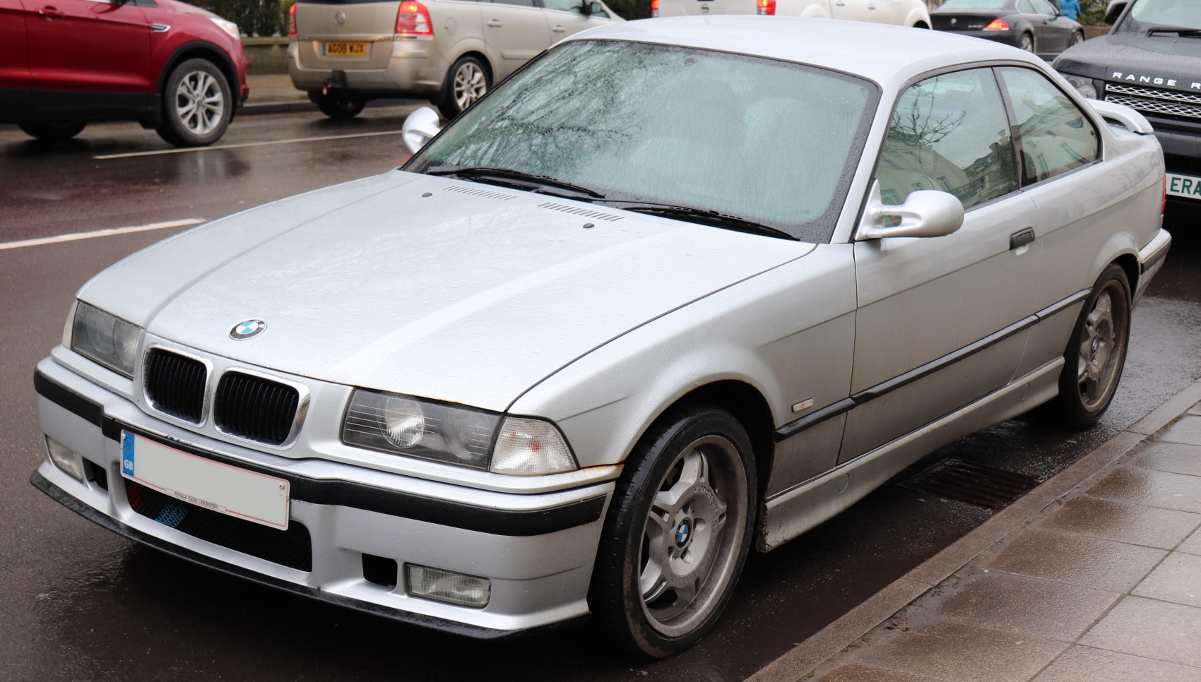 Front and side view of classic silver coupe with kidney grille and alloy wheels