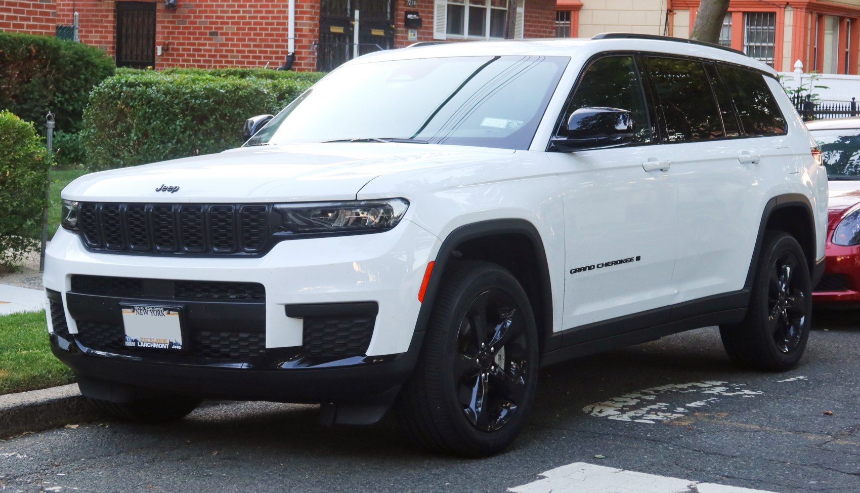 White SUV with black grille and wheels parked on street