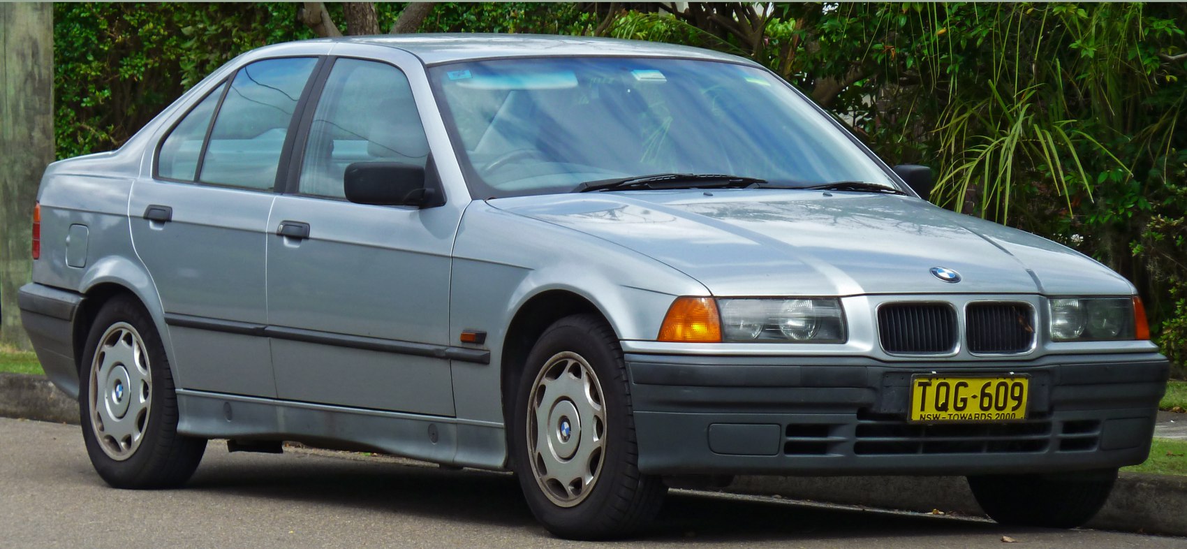 Four-door sedan with alloy wheels, front grille, and headlights