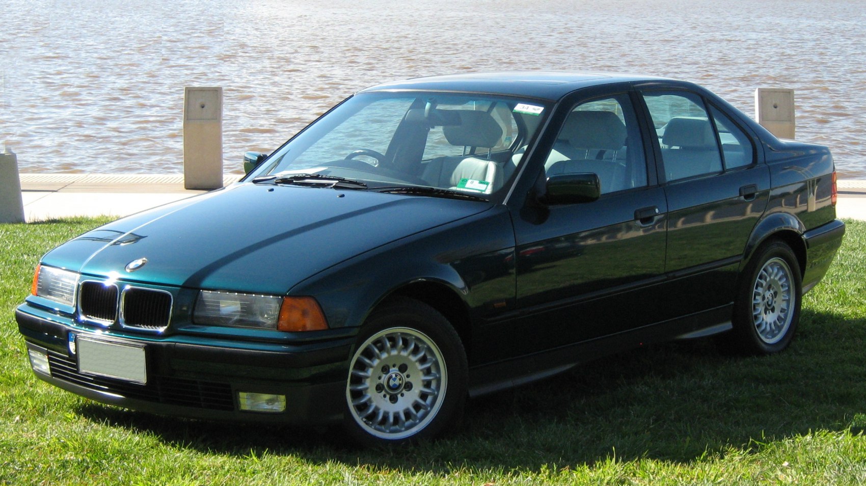 Front angle of sedan with distinctive headlights and alloy wheels
