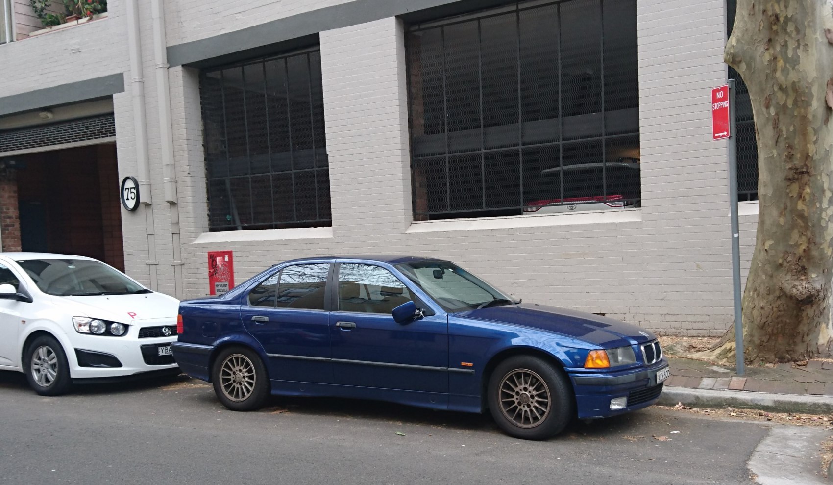 Blue classic sedan side profile with alloy wheels