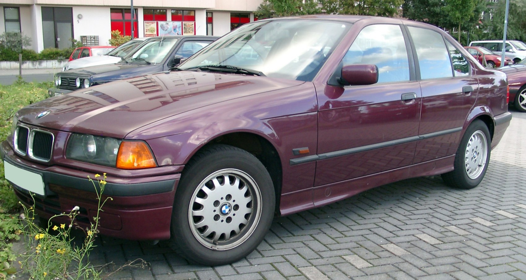 Classic sedan front side view with alloy wheels and orange indicators