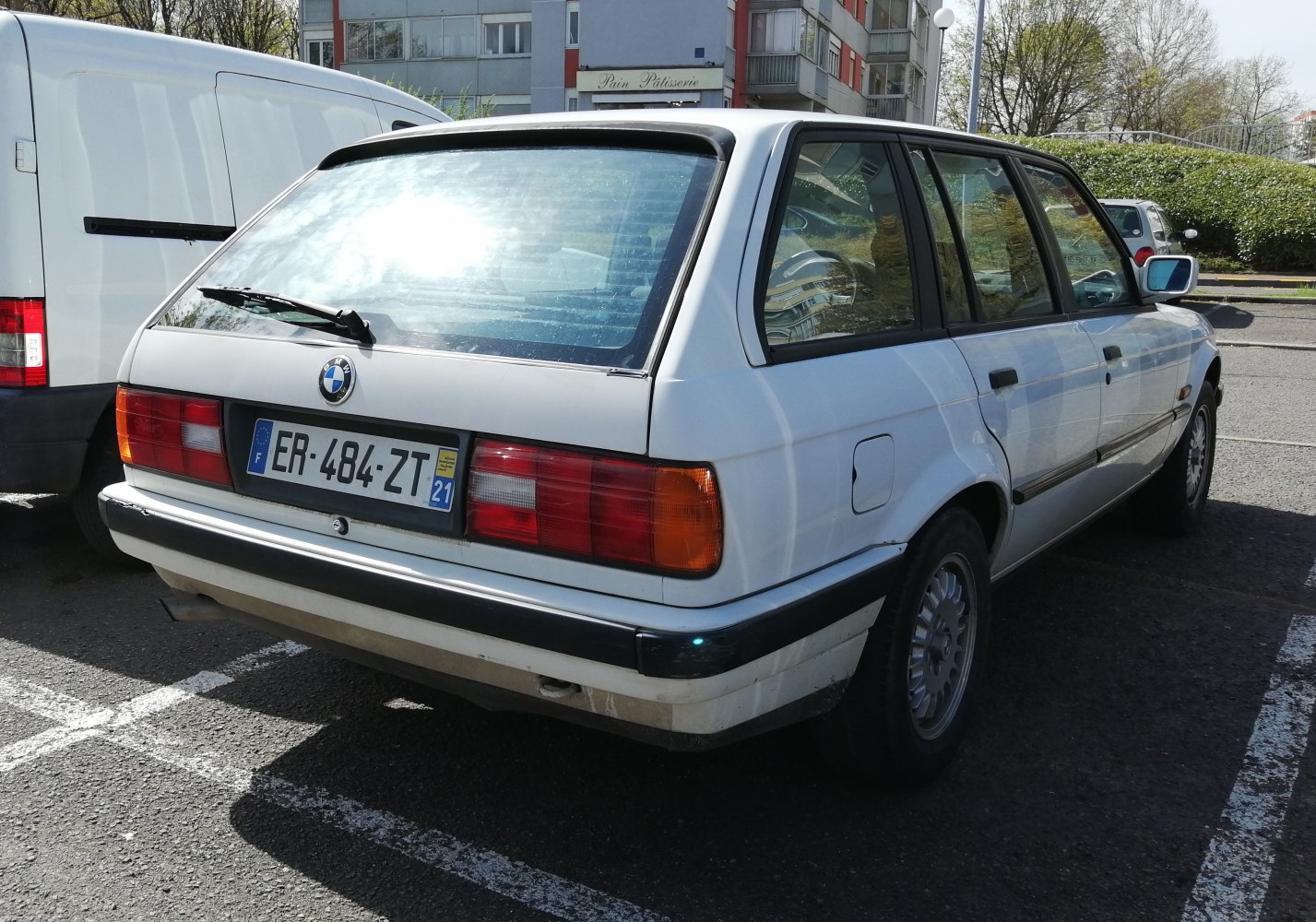 Rear view of classic E30 station wagon with distinctive tail lights and hatchback design