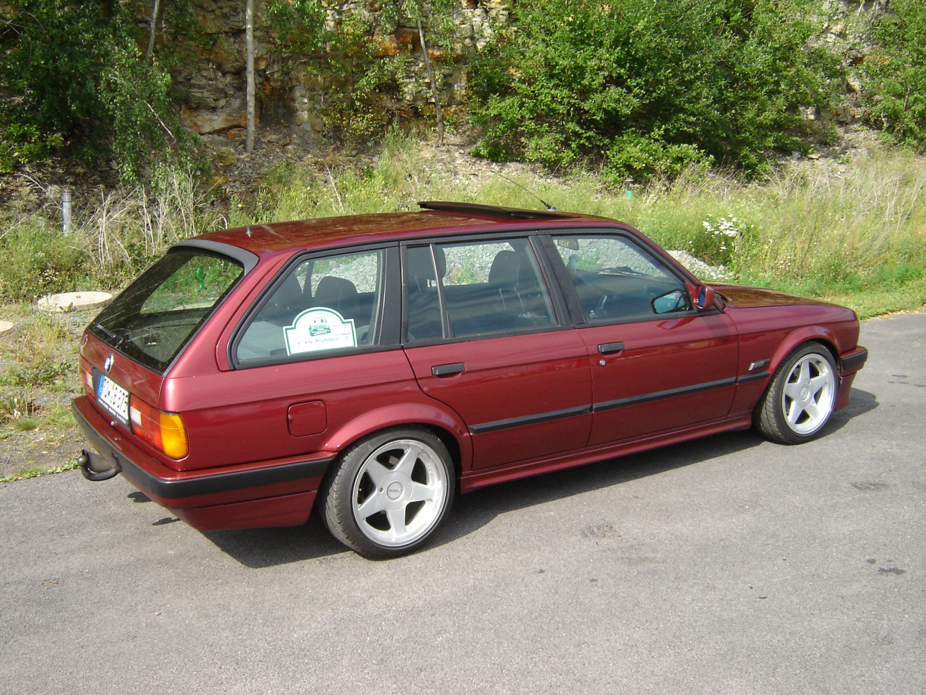 Burgundy red estate with sunroof and alloy wheels