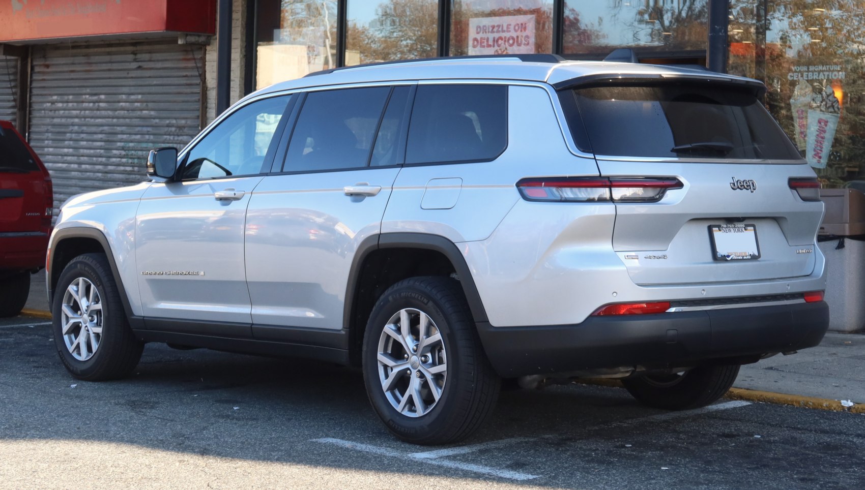 Silver SUV rear and side view with alloy wheels, tinted windows, and 4x4 badge