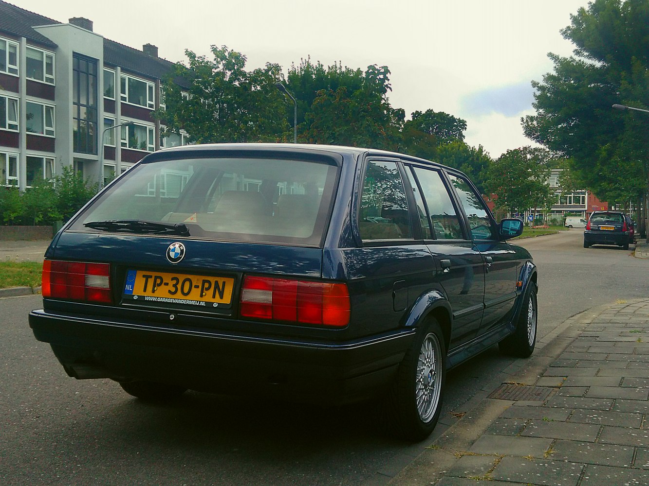 Rear view of classic station wagon with distinctive taillights and alloy wheels