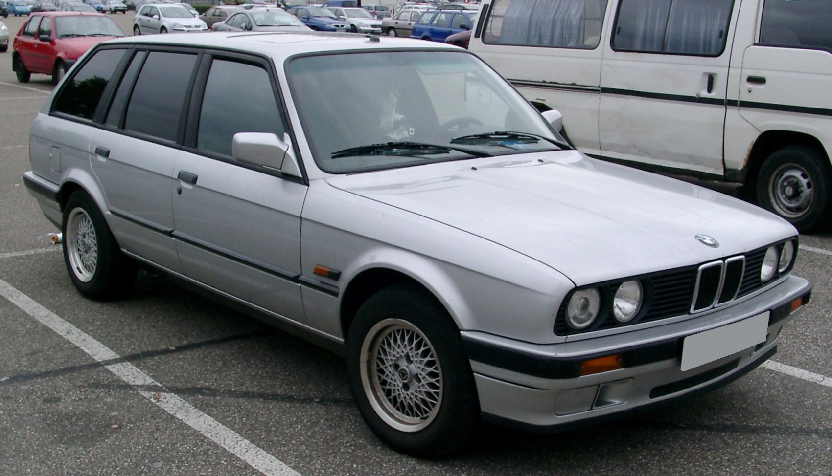 Silver station wagon with quad round headlights and mesh wheels
